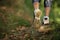 Woman feet in shoes on a forest path on sunset