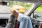 Woman feet in socks on car dashboard. Man driver holds the hand of a female passenger traveling on the highway. Couple on a trip.