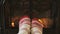 Woman Feet In Socks Relaxing Warming by Fireplace Getting Warm Relaxing