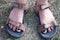 Woman feet in sport sandals in Green Field