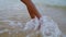 Woman feet walking ocean waves closeup. Unknown playful girl enjoying beach