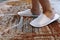 Woman feet wearing white hotel slippers walking on hotel floor