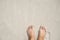 Woman feet on white sand beach. Relaxed barefoot tourist by sea. Seaside banner template with text place.