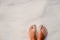 Woman feet and white sand texture. Relaxed tourist on beach. Tropical vacation banner template with text place