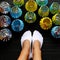 Woman feet in white socks and handmade lanterns recycling from beer cans