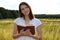 Woman in field with book