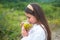 Woman in field. Healthy lifestyle. Carefree girl in meadow with wildflowers.