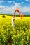 Woman in fields of golden canola