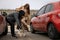 Woman fighting with thief while he trying to steal her bag on parking lot. Self defense concept