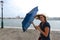 Woman fights wind with umbrella in Venice, Italy