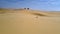 Woman Figure Does Sadhana among Desert Panorama