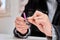 Woman filing and shaping her nails after applying nail decals.