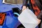 Woman filling a diesel engine fluid from canister into the tank of blue car. Diesel exhaust fluid for reduction of air