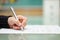 Woman is filling document on glass table, shallow depth of field