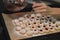 Woman filling jam into Christmas cookies