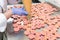 Woman Filling Pink Macarons Shells With Ganache