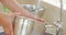 Woman filling pot with water from the tap