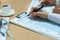 Woman filling in U.S. Individual income tax return, tax 1040 at table.