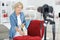 Woman filming herself measuring chair for blog