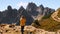 Woman films mountains with camera at Three Peaks of Lavaredo