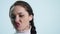 Woman finger brushing her teeth on white background