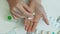 Woman fingering pills in her hand, Tablet in hand,