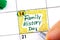 Woman fingers with pen writing reminder Family History Day in calendar