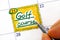 Woman fingers with pen writing reminder Golf course in calendar.