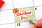 Woman fingers with pen writing reminder Volunteer Day in calendar