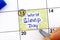 Woman fingers with pen writing reminder World Sleep Day in calendar