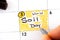 Woman fingers with pen writing reminder World Soil Day in calendar