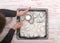 Woman finishing freshly baked traditional new year cookies on tr