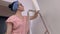 Woman finishing paint wall