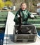 Woman fish farmer holding sturgeon