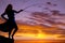 Woman fish pole sunset