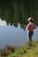 Woman fishing in lake