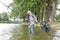 woman fishing in the river in spring