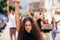Woman, fist and portrait with protest crowd in street for planet, climate change or sustainable future. Girl, leadership