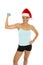 Woman in fitness clothes and santa claus Christmas hat holding weight dumbbells