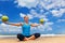 Woman fitness exercise with green coconuts on ocean beach