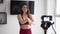 Woman fitness instructor records a tutorial at home, introduction