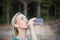 Woman fitness runner drinking water