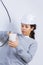 Woman fitting electrical outlet in bathroom