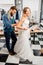 Woman fitting wedding dress at the tailor studio