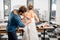 Woman fitting wedding dress at the tailor studio