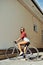 woman on a fixed gear bicycle outdoor fashion portrait