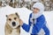 A woman fixes her dog`s collar. Alabai walks with his mistress