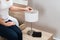 Woman fixing lamp at home