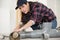 woman fixing pipes in home