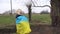 woman flag of ukraine near burnt tree